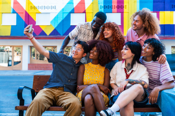 Multiethnic group of young friends meeting and having fun outdoors